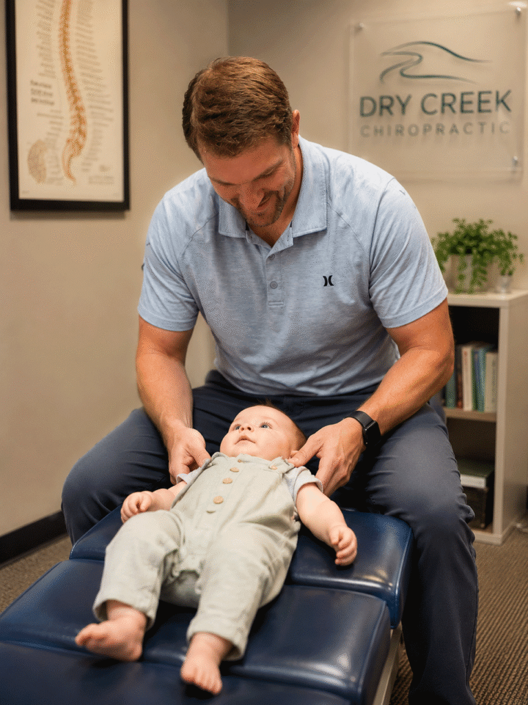 Dr. Aaron Walker adjusting an infant at Dry Creek Chiropractic in Lehi, Utah
